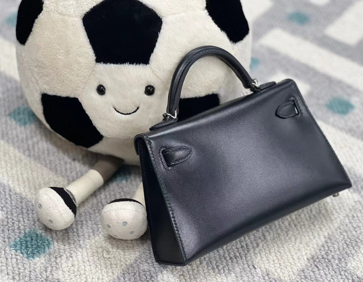 Mini bolso de piel con tachuelas de paladio