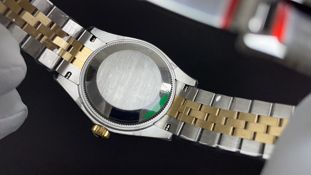 Reloj automático dorado y verde de 31 mm